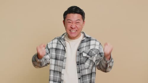 Excited Man Celebrates Success With Fists Pumped