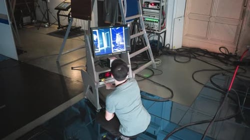 Person Working with a Touchscreen Display in a Studio Environment Adjusting Settings on a Control