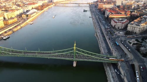 4K aerial drone shot of Liberty Bridge in Budapest Hungary with a view of Danube river during sunset