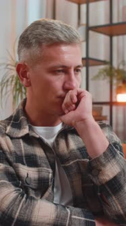 Thoughtful Man Sitting at Home Looks Pensive Thinks of Unrequited Love Depressed Bad Feeling Burnout