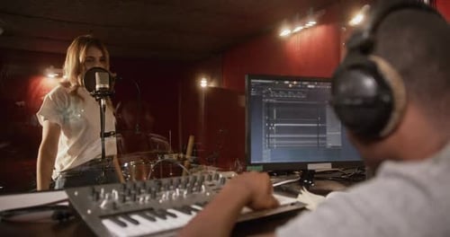 Sound Engineer and Singer in Recording Studio