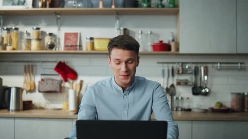 Man Making Conference Video Call on Laptop Sitting at Home Kitchen Close Up