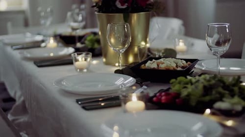 Table setting with plates, cutlery, salads and flowers