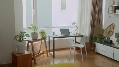 Home Office Interior with Laptop on Desk by Window