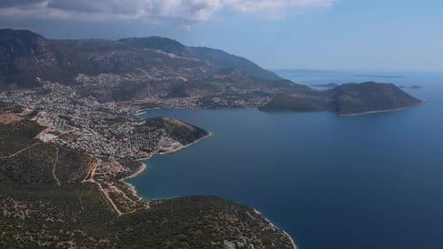Aerial View of a Coastal Turkish Town Surrounded By Mountains and Deep Blue Sea