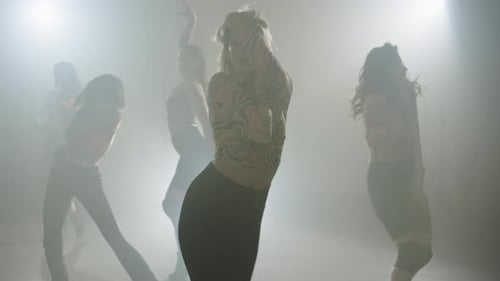 Stylish Women Dancing in Smoky Studio, Synchronized Performance