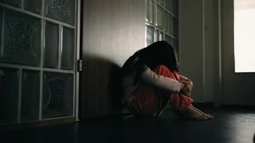 Lonely depressed child covering face in shame, little girl struggles with mental illness sitting in