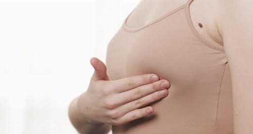 Woman Checking Her Breast for Signs of Breast Cancer Healthcare and Mammology Concept Close Up
