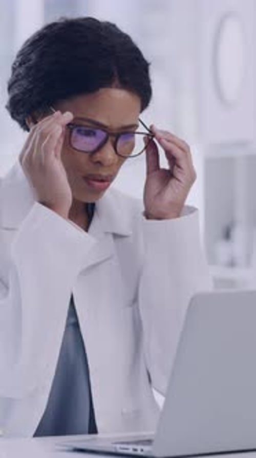 Woman Doctor Working on Laptop in Office