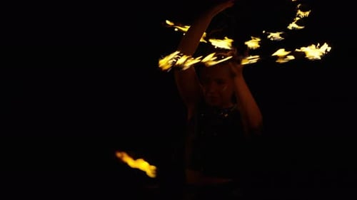 Fire Dancer Swirling Flames at Night