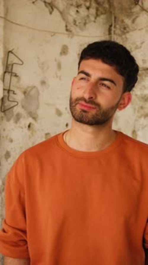 Young Adult Man Holding Lightbulb in Urban Setting