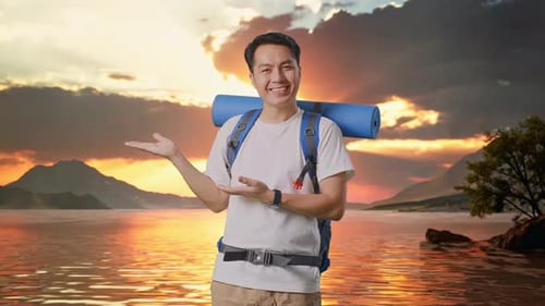 Asian Male Hiker Smiling And Pointing To Side At A Lake