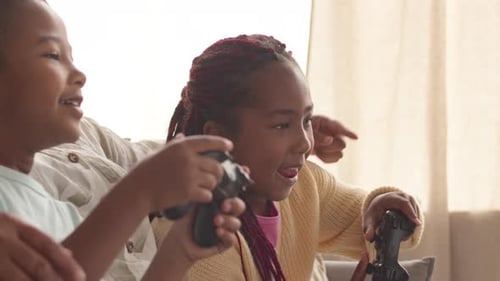 Boy and Girl Playing Video Games on Couch