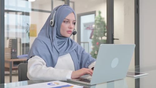Woman in Hijab with Headset Working in Call Center