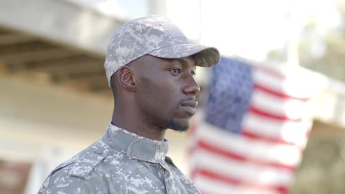 Young Man in Military Uniform With Flag