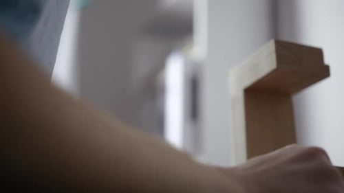 Hands Working on Wood at Grinding Machine