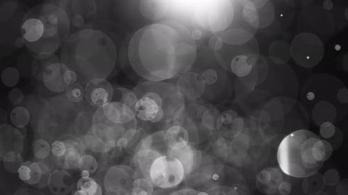 Floating abstract particle bokeh on dark background. Shot on super slow motion camera 1000 fps.