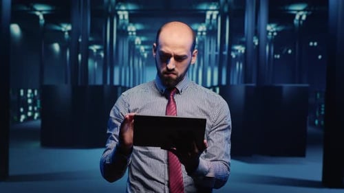 Male Infrastructure Specialist Using Tablet for Hardware