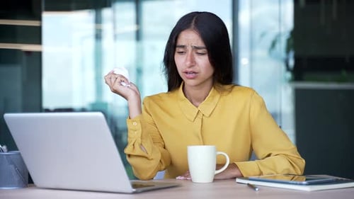 Sad Woman Crying at Work with Laptop