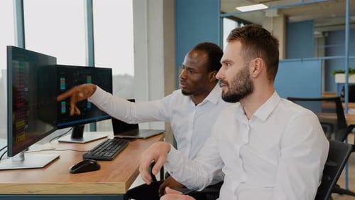 Team of Stockbrokers are Having a Conversation in Office with Display Screens Analyzing Data Graphs