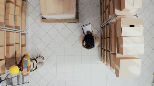 Aerial View of Workers Inspecting Inventory in Warehouse