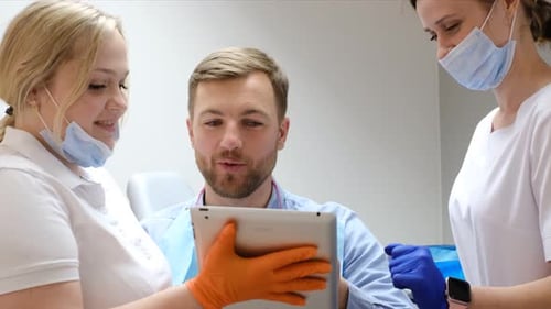 Man Discussing Treatment with Dentists in Clinic