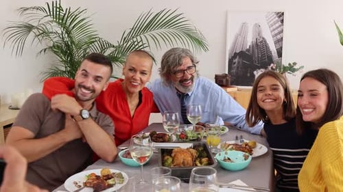 Family Taking Picture at Dinner Table