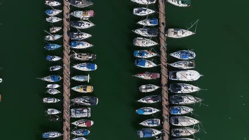 Boats and small sailing Yachts docked in a beautiful marina, Top down view