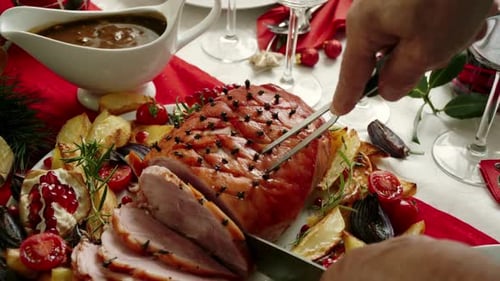 Festive Ham Slicing at Christmas Dinner Table
