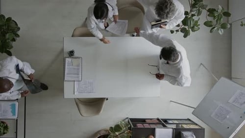 Top View of Chief Hospital Surgeon Greeting Colleagues Arriving for Meeting