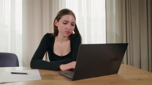 Woman Working on Laptop at Home Office