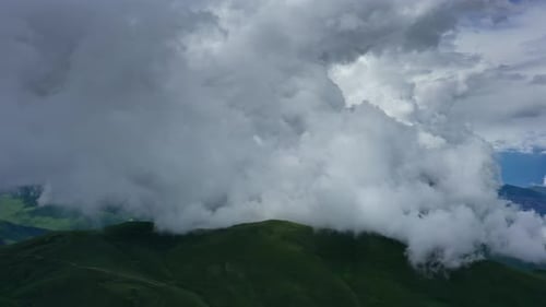 Aerial View of Green Mountains with Cloudy Sky