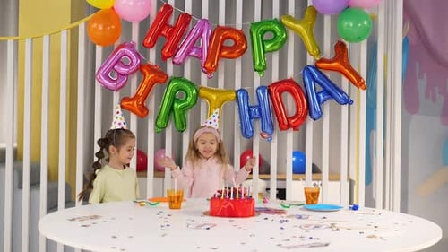 Smiling Girls Celebrating Birthday Party with Cake