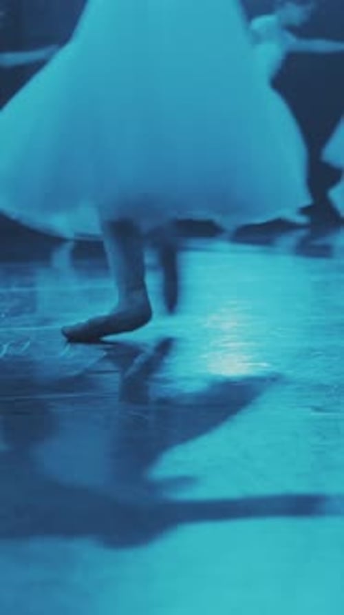 Ballerinas run in a circle on the stage. Close-up of the legs. Vertical format for the phone.