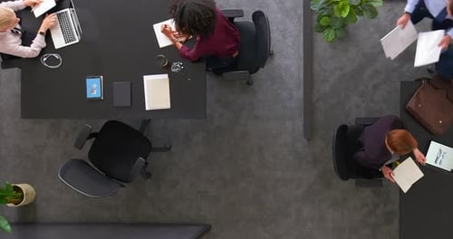 Timelapse of a productive team of employees working together in the office from above