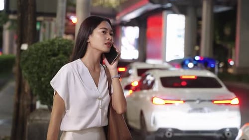 Young Businesswoman Walking and Talking on Phone in Bangkok Bangkok Night Lifestyle