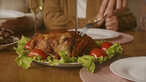 Cutting Roasted Turkey at Holiday Family Dinner