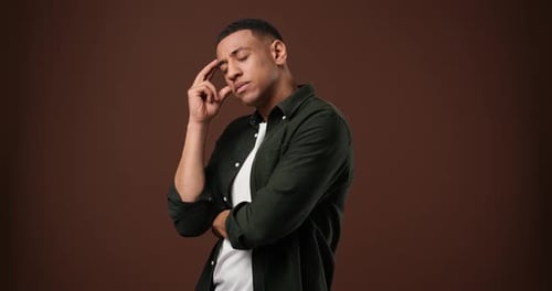 Man Thinking Deeply with Hand on Head