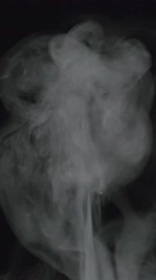 White Smoke Rising on Dark Vertical Background