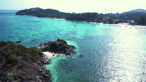beach rocky cliff island turquoise blue sea. Breathtaking aerial top view flight overflight flyover