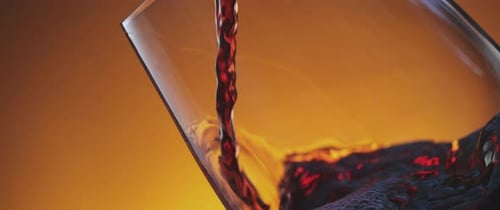 Dark Red Liquid Being Poured Into Glass