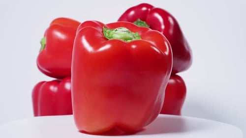 Red paprika rotating on a white background. Red fresh pepper. Close-up. High quality 4k footage