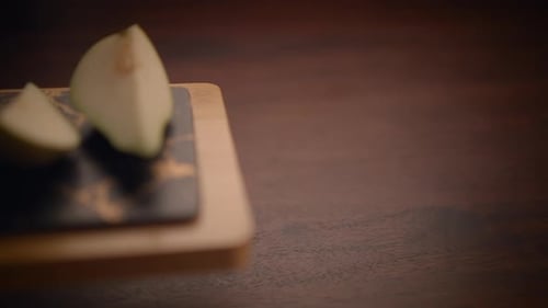 Pear slices on charcuterie board on wooden table