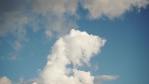 Drifting White Clouds in a Blue Sky