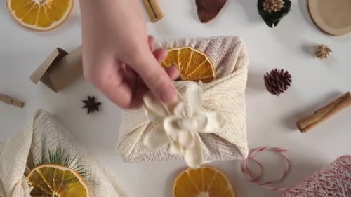 Decorating Furoshiki Gift with Orange Slice and Flower
