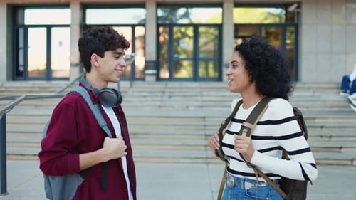 Smiling diverse young male and female university students in casual clothes with backpacks