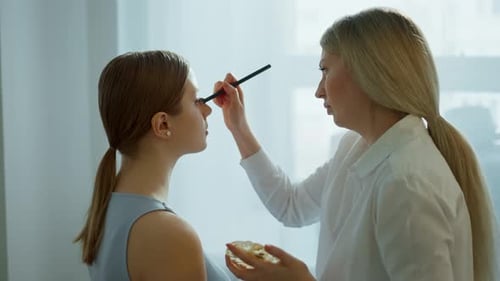 Makeup Artist Work in Her Beauty Studio Portrait of Woman Applying By Professional Make Up Master