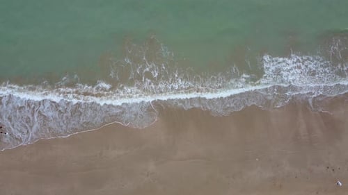 Awesome aerial view of sand beach and white-crested waves