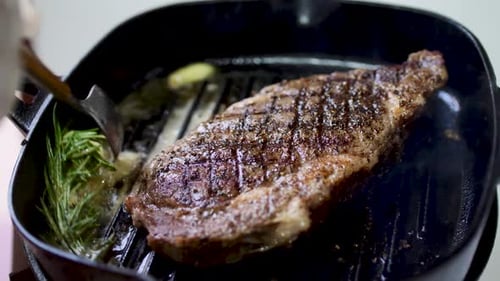 Rib eye steak fried on hot pan 4K.