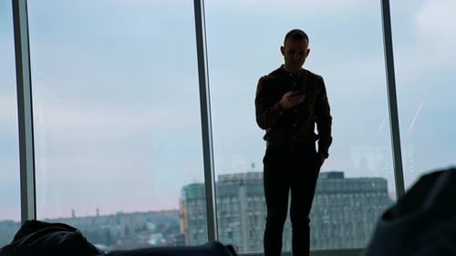young businessman using smartphone in office